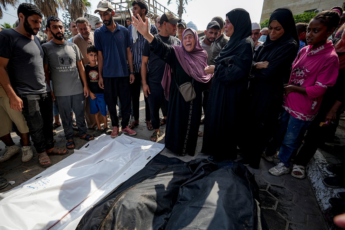 AP : Palestinians mourn their relatives killed in the Israeli bombardment of the Gaza Strip in a hospital in Deir al-Balah, Sunday,